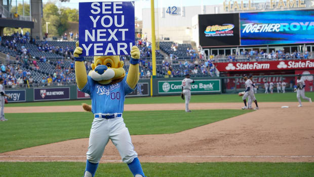Oct 3, 2021; Kansas City, Missouri, USA; The Kansas City Royals mascot Sluggerrr displays a sign to the fans after the loss to the Minnesota Twins at Kauffman Stadium. Mandatory Credit: Denny Medley-USA TODAY Sports